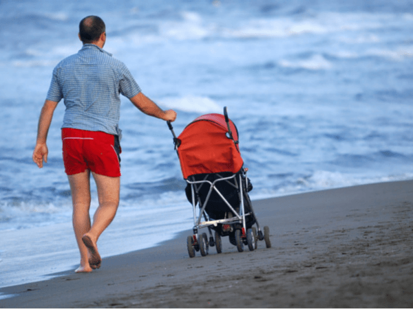 pushing stroller on the beach